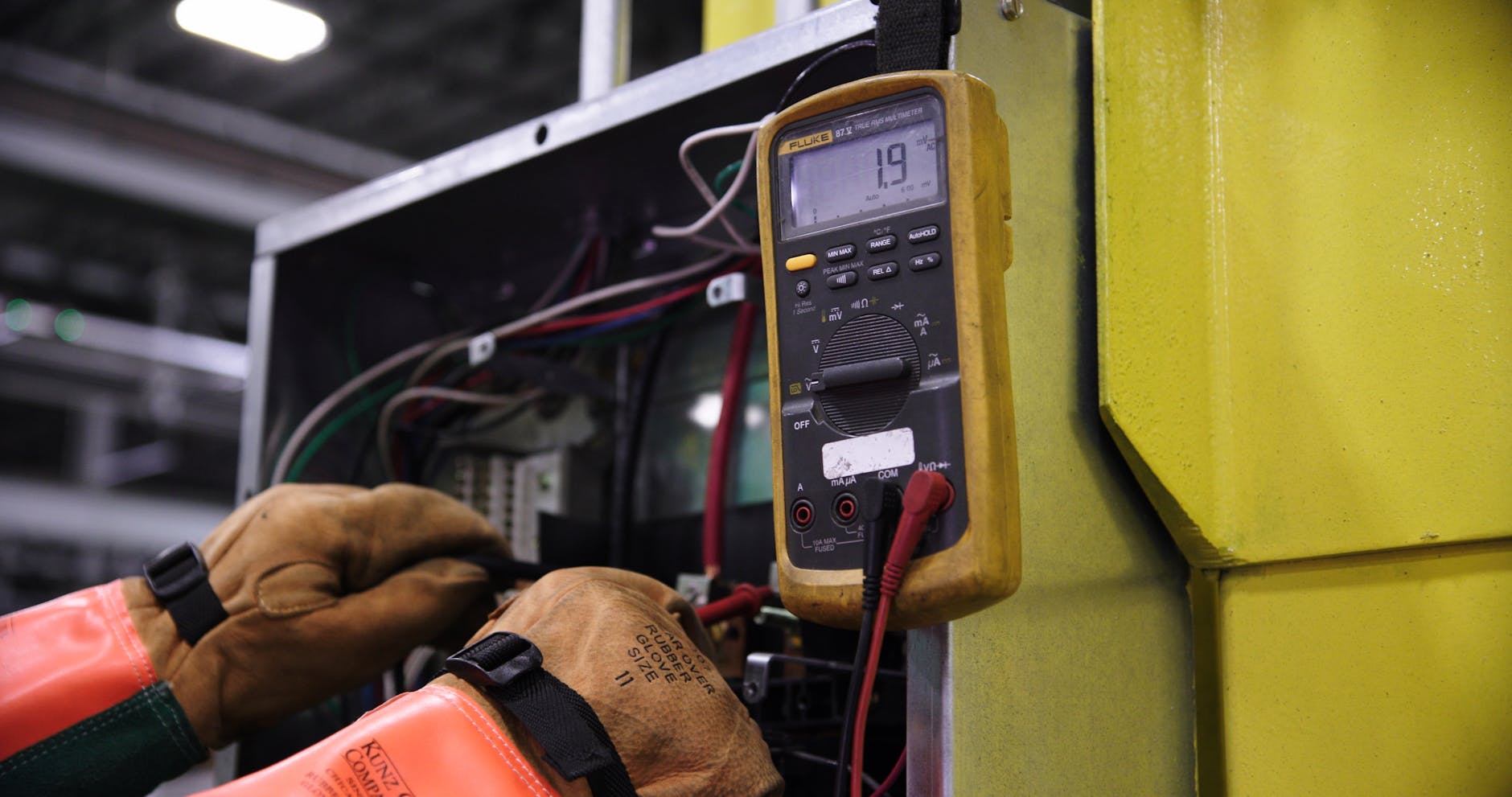 electrician hands connecting wires in fuse box