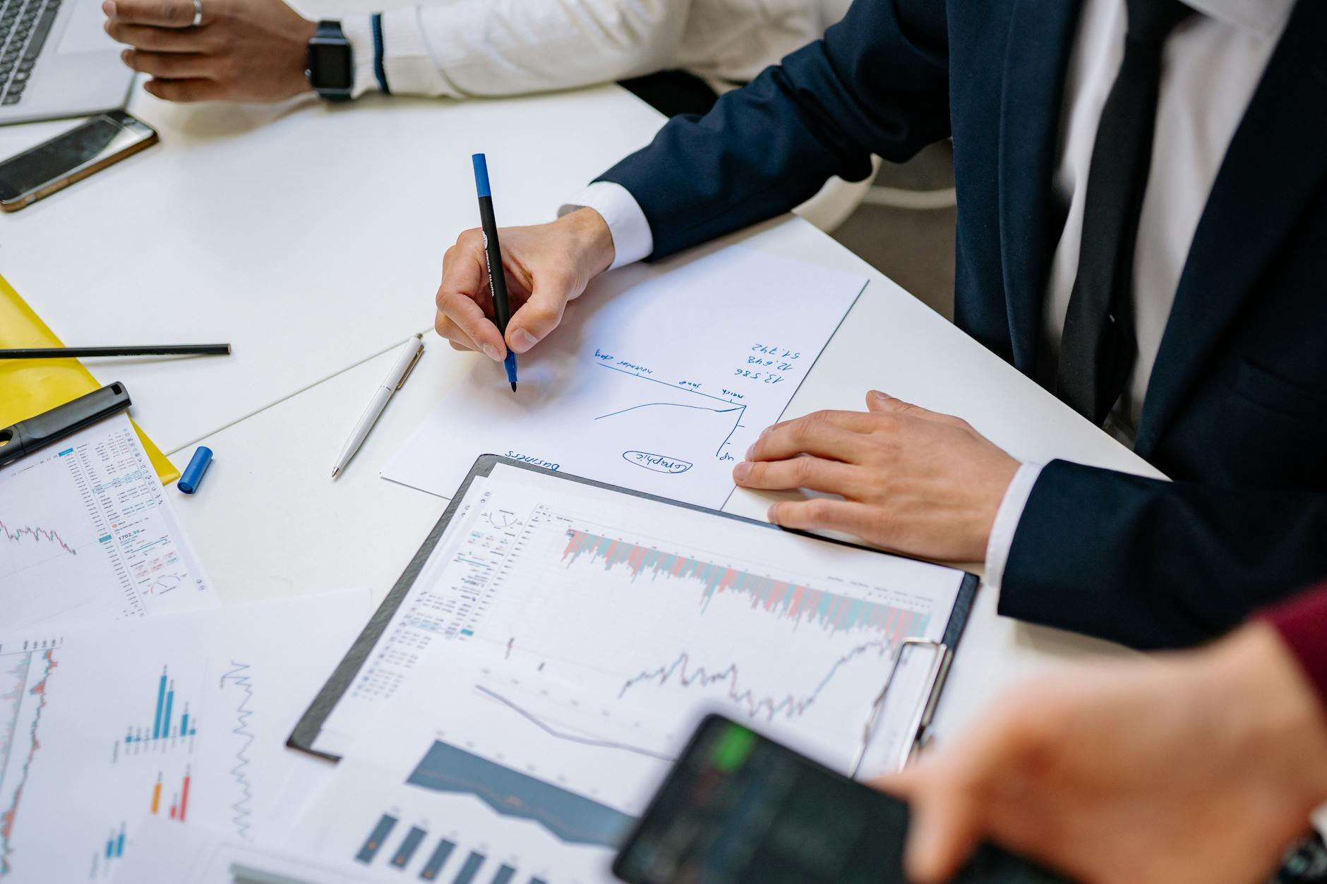 Business people discussing finance charts office