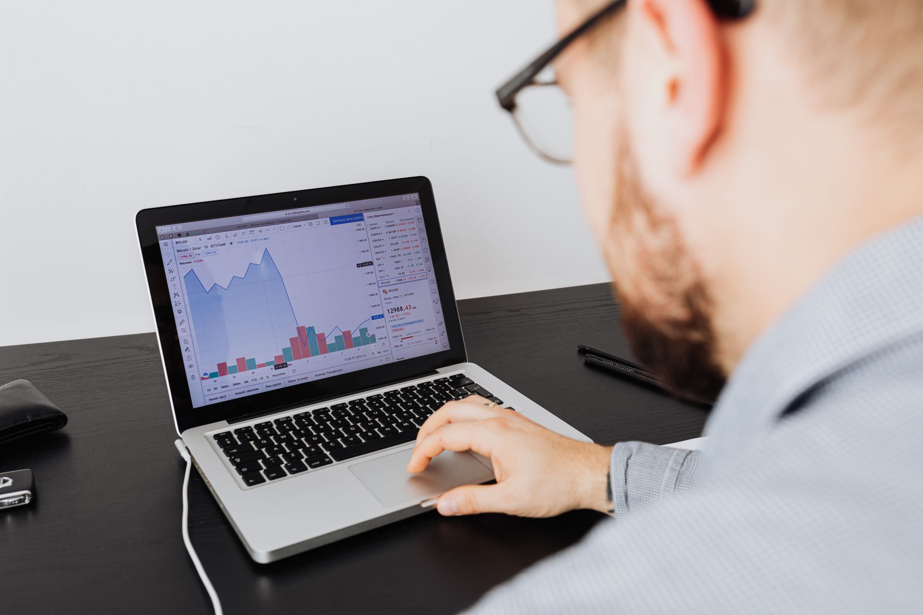 businessman reviewing financial charts laptop