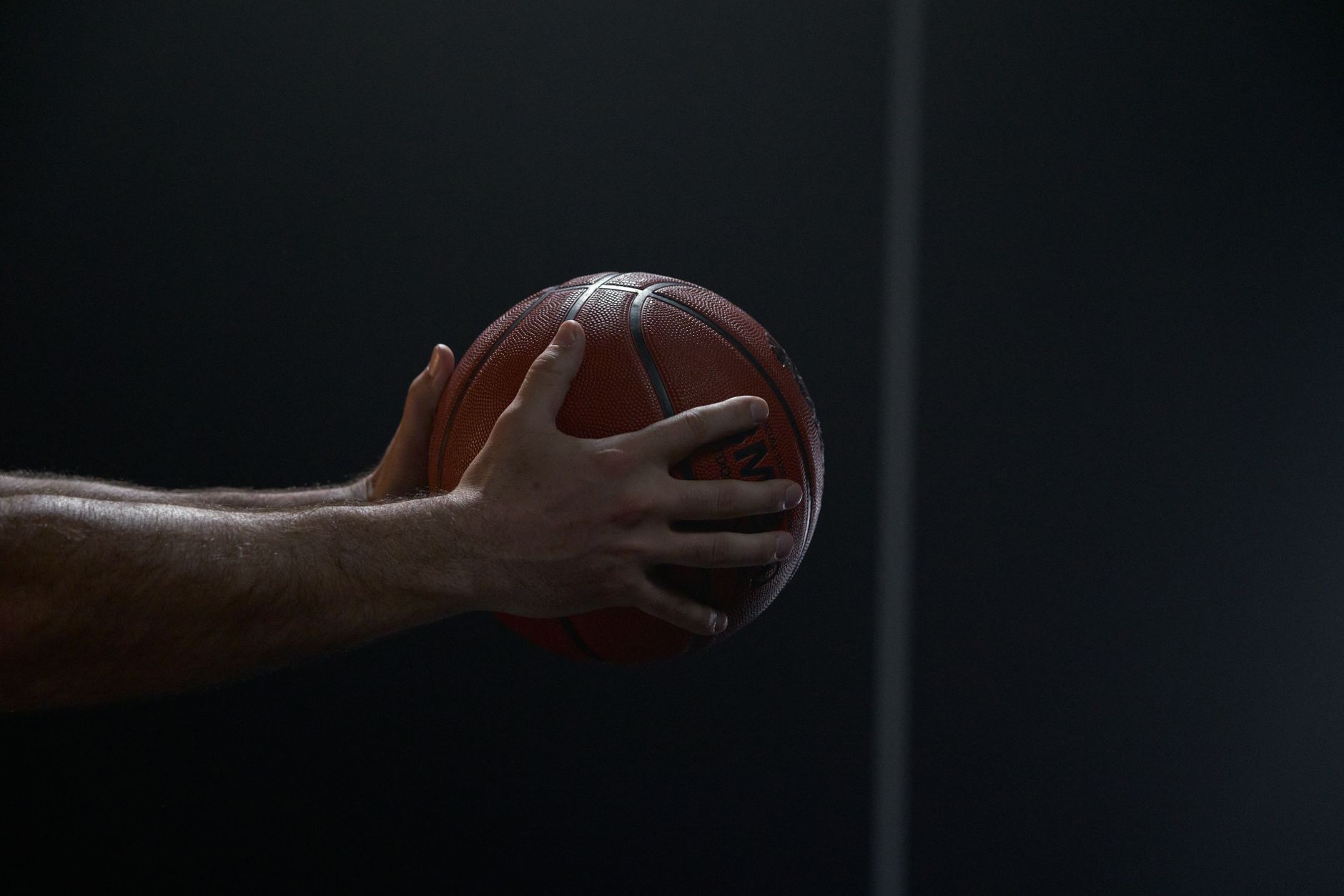 basketball player dribbling ball on court close-up