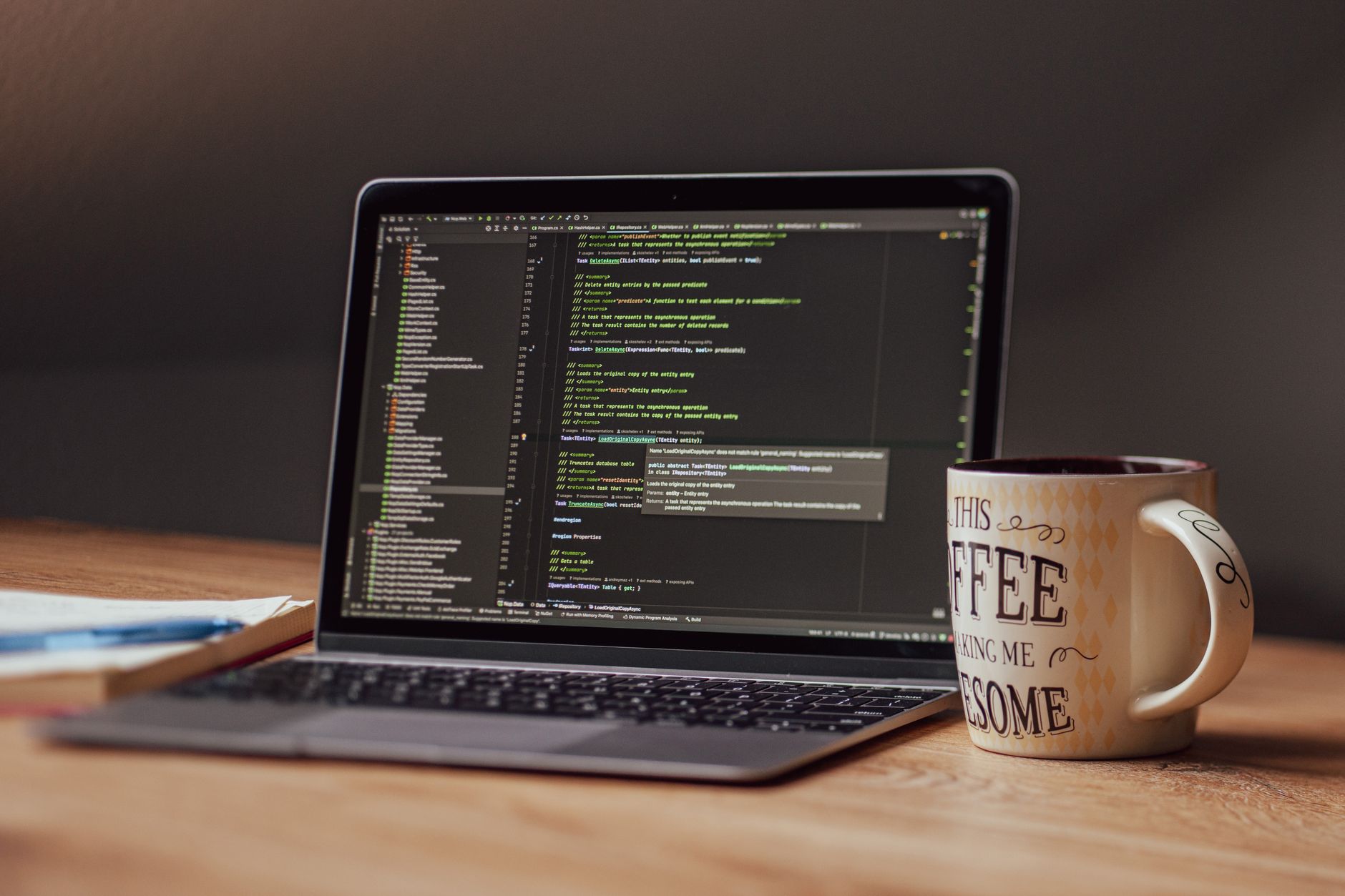 open laptop on wooden desk with coffee mug