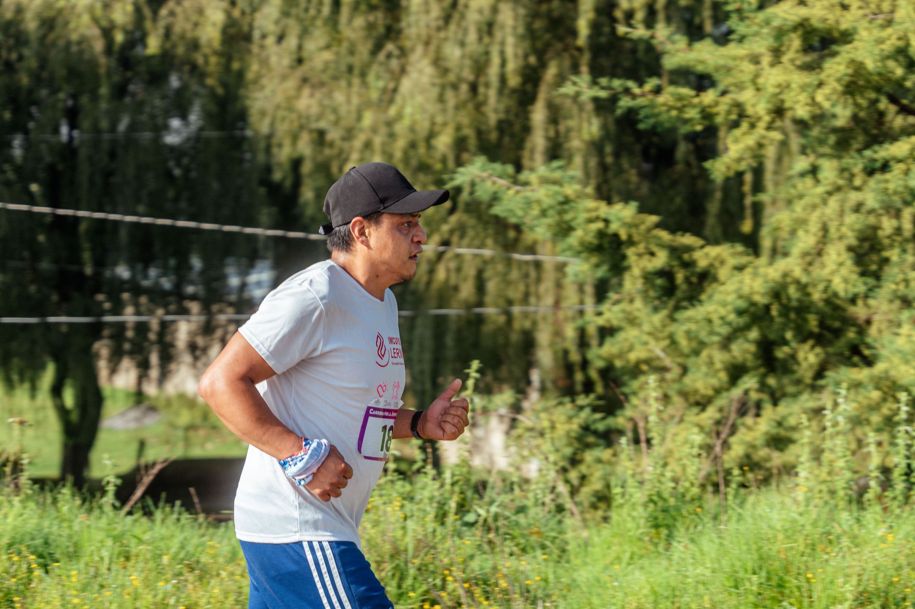 person jogging with smartwatch in park morning