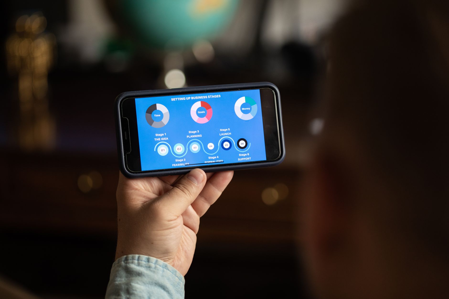 person holding smartphone looking at electricity bill app