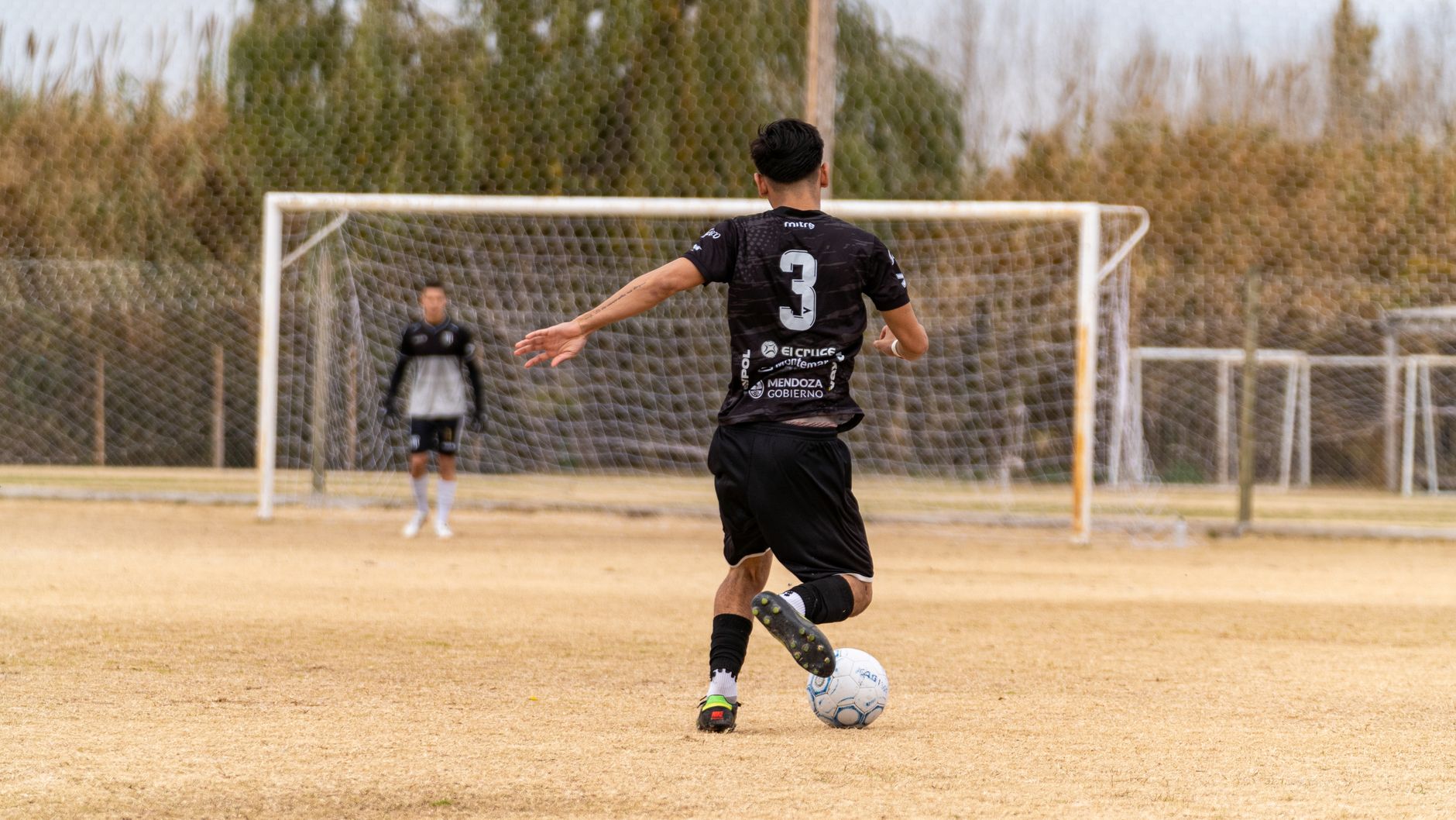 soccer player defending goal during match
