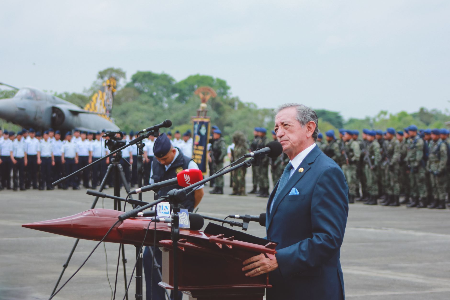 government official speaking at podium microphone
