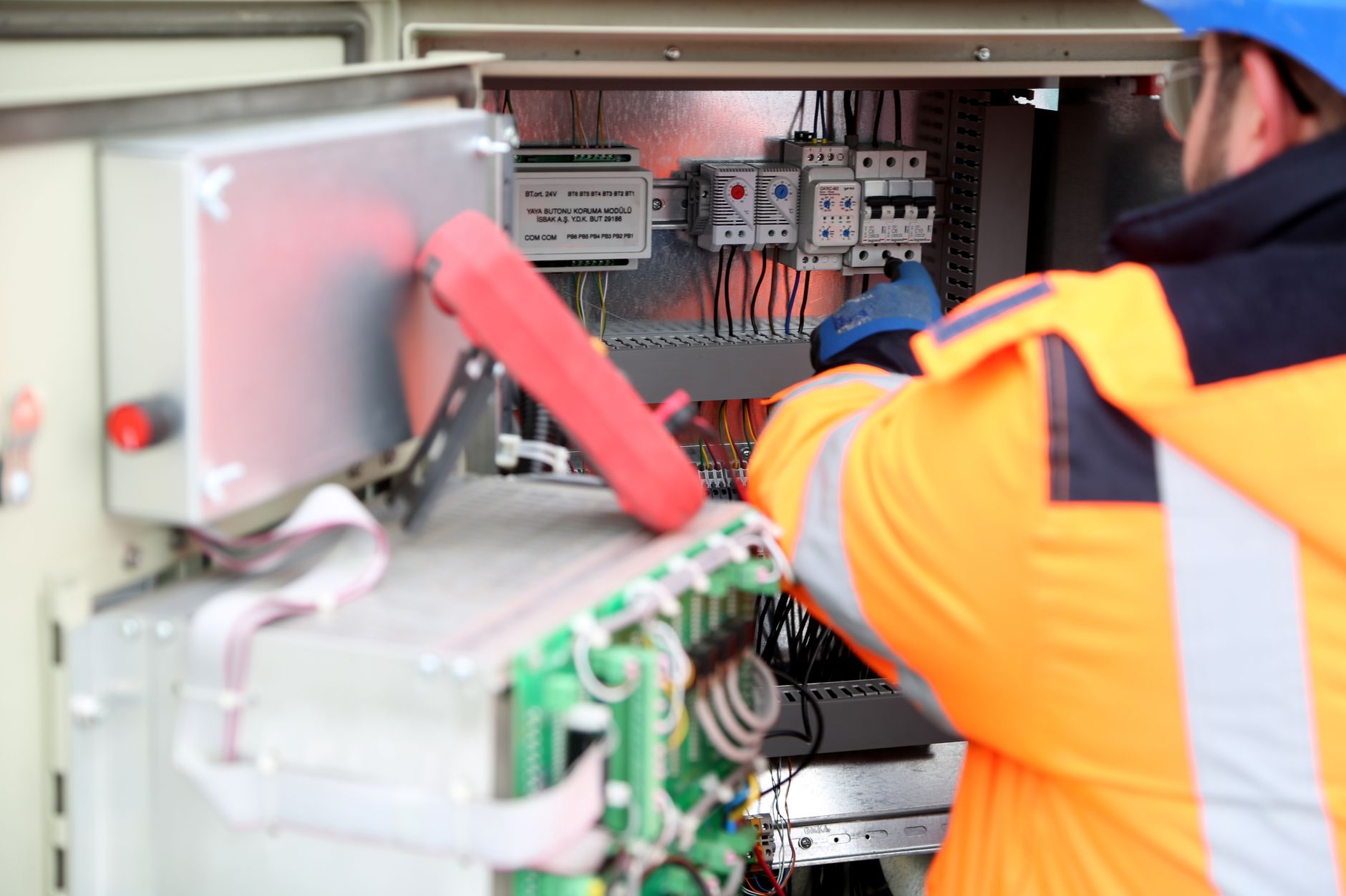 electrician hands connecting wires in fuse box