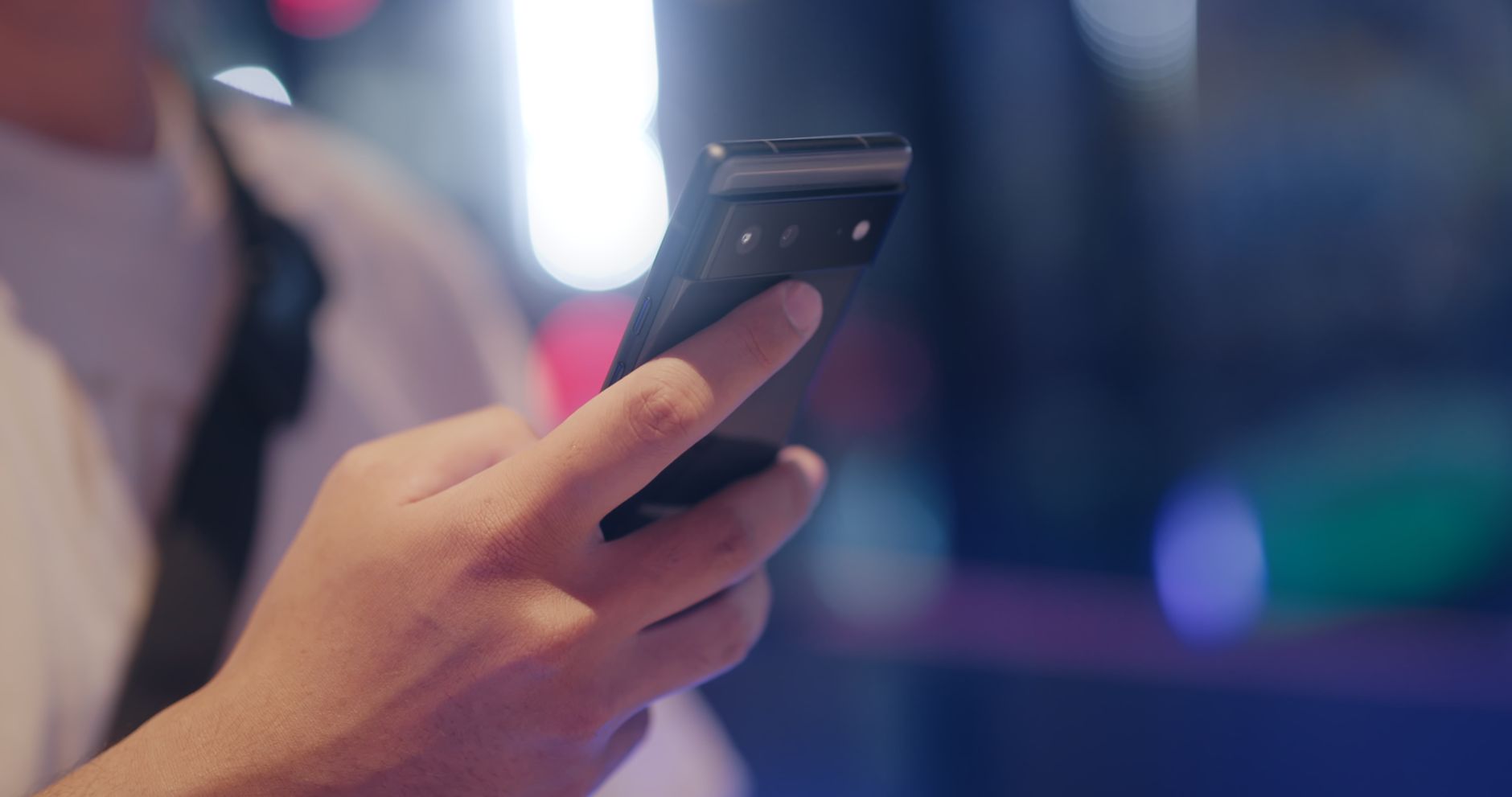 person holding smartphone comparing network speeds