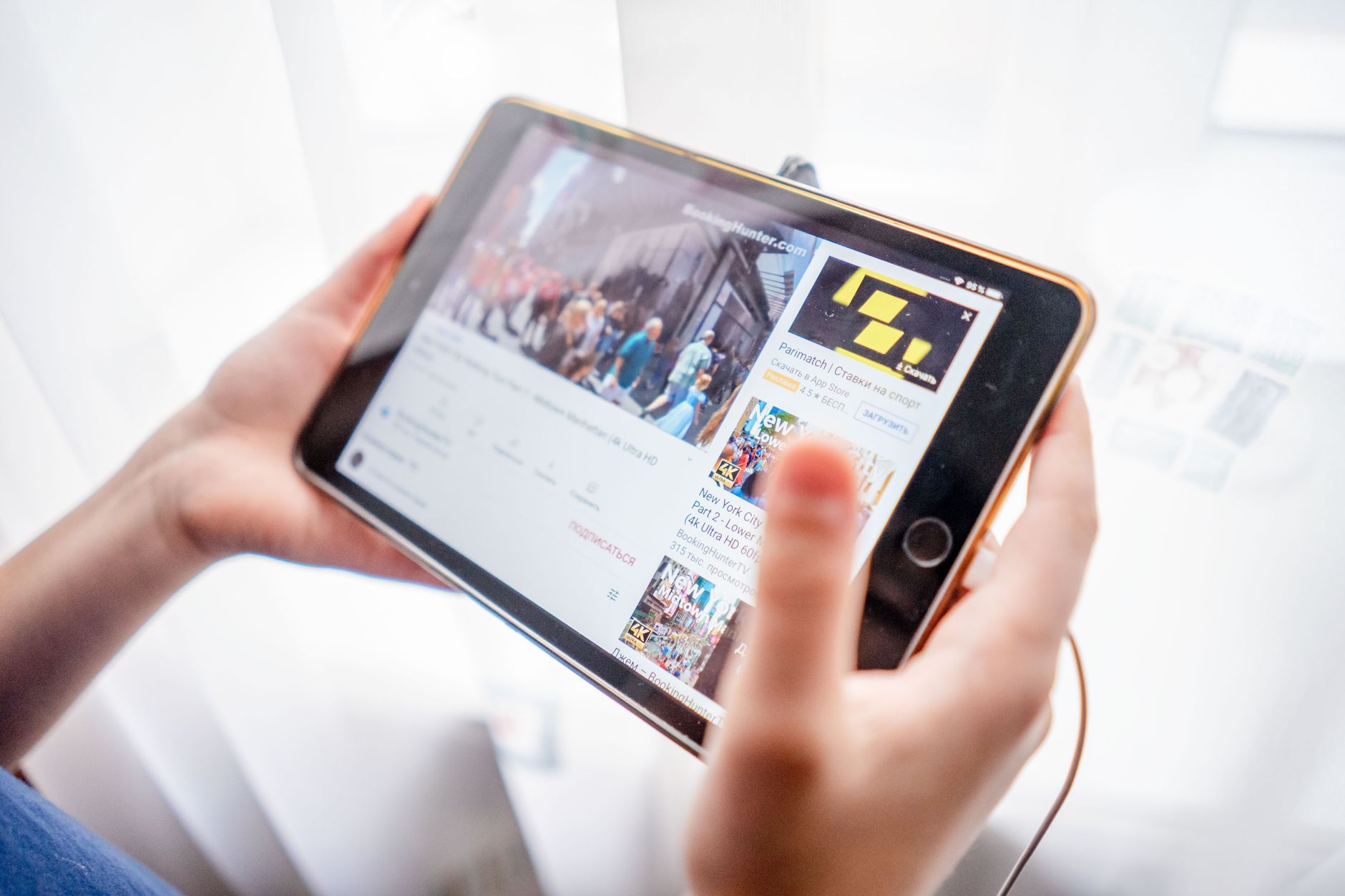 hands holding tablet browsing website