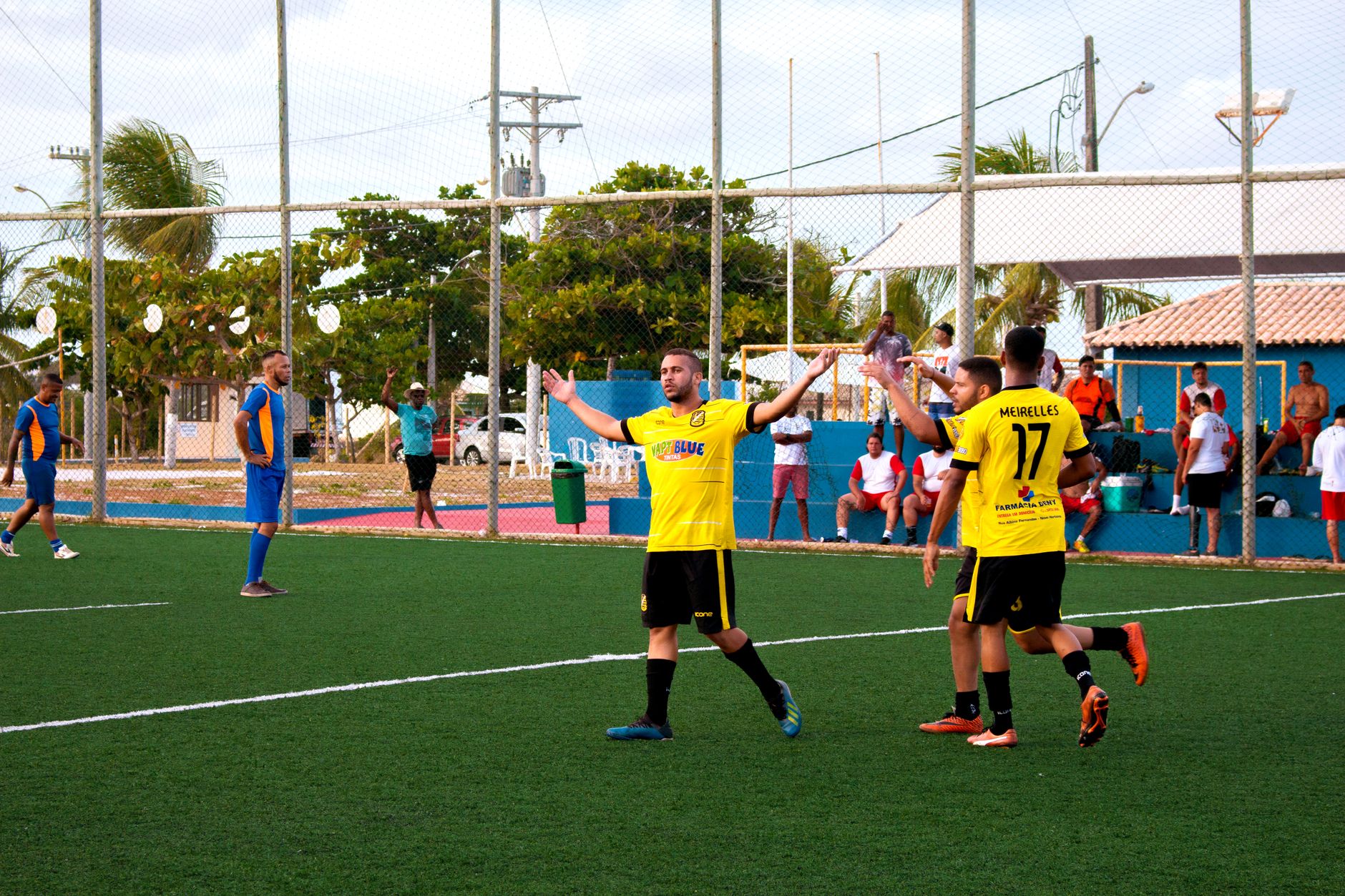 football players celebrating goal on green field
