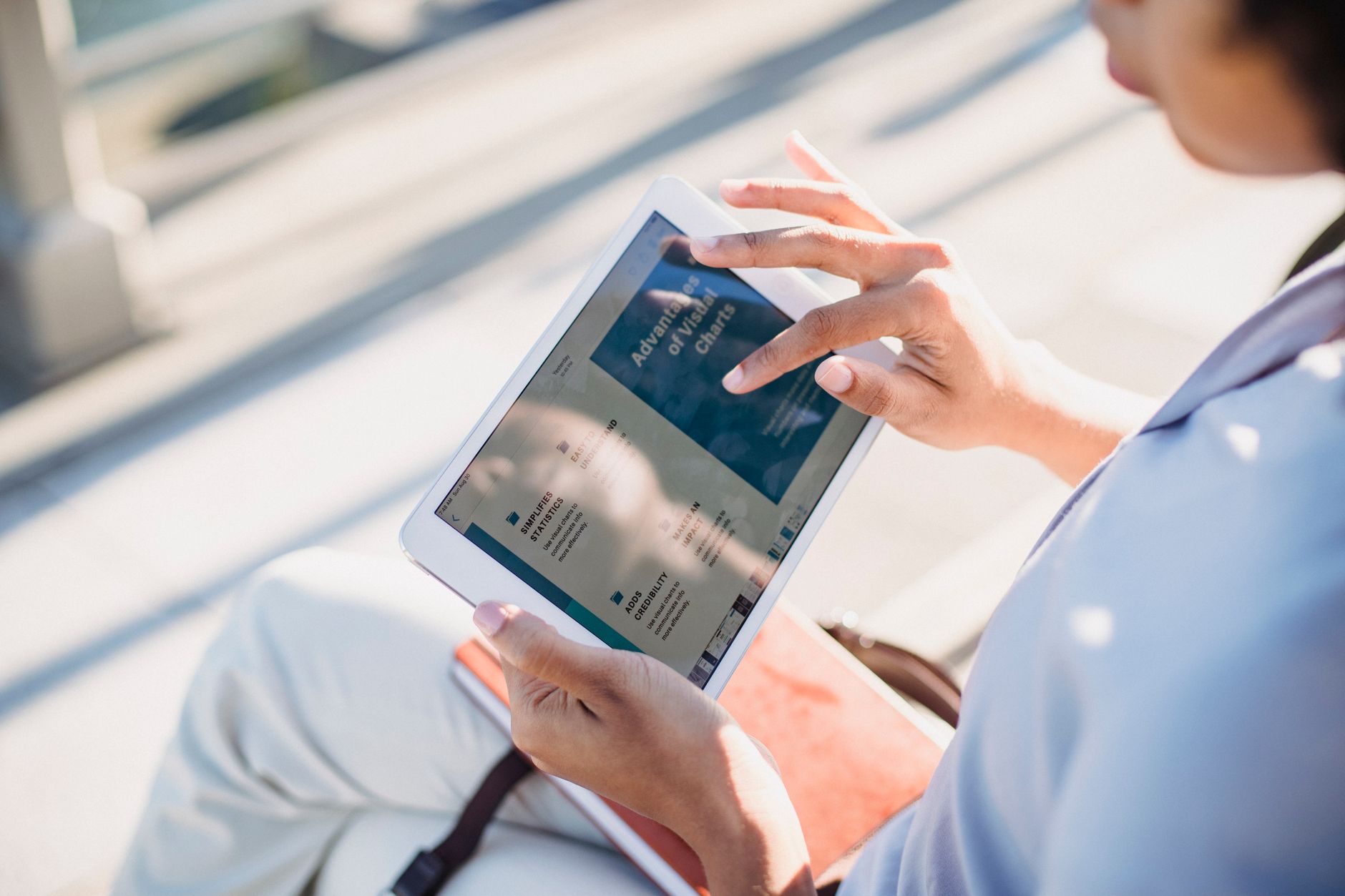 hands holding tablet browsing website