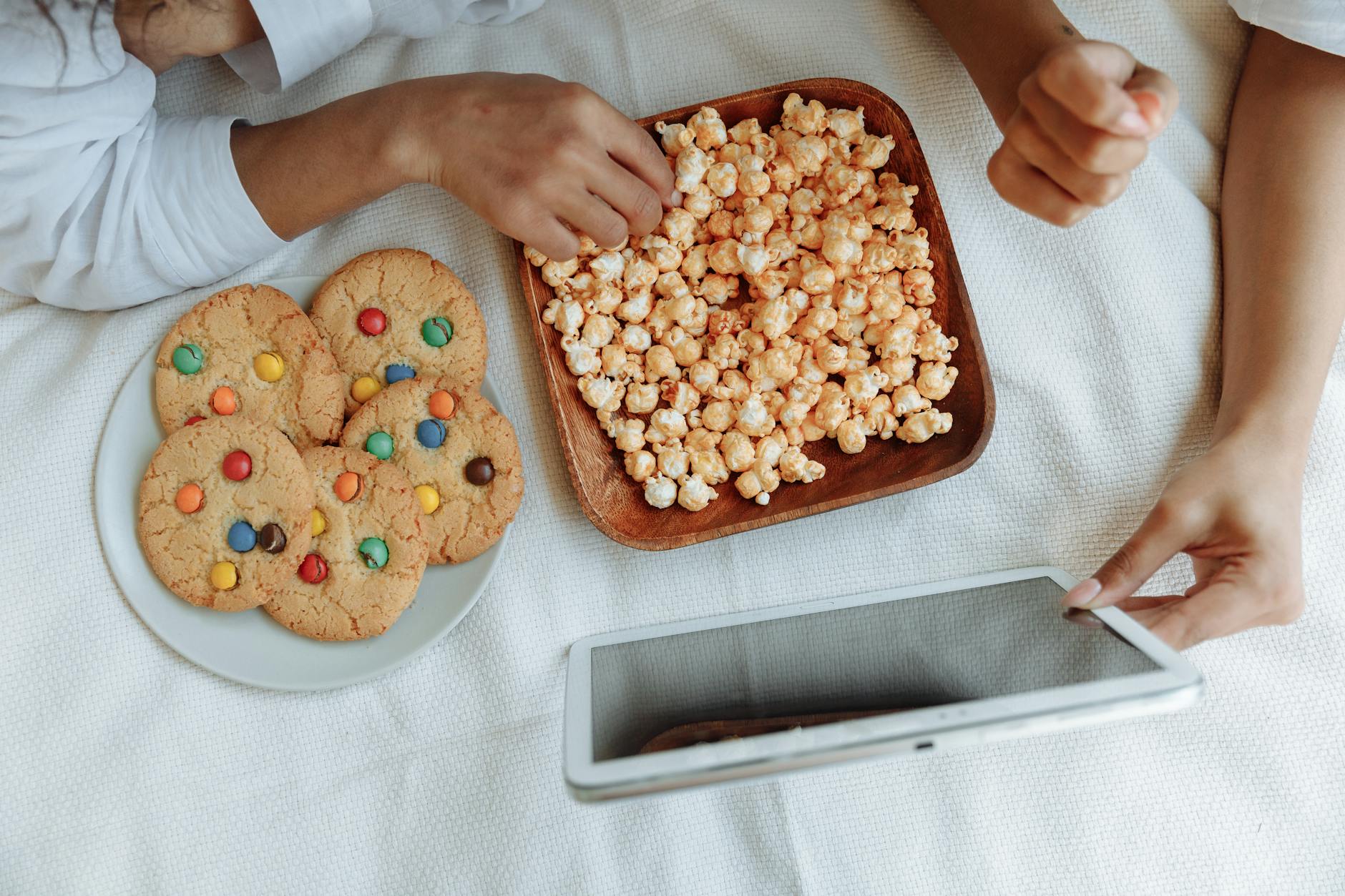 hands holding tablet watching movie streaming