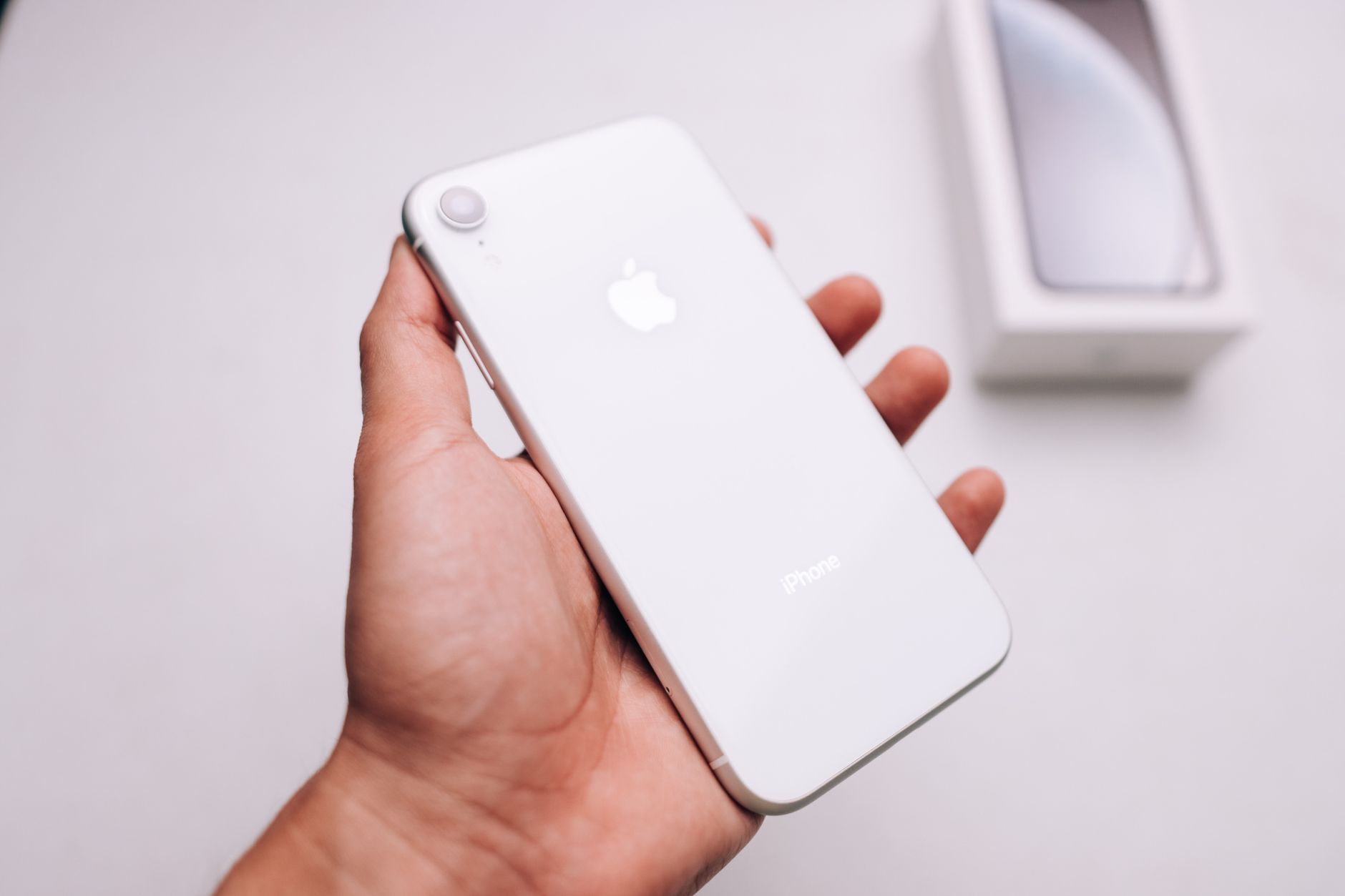 hand holding latest android smartphone with bright screen