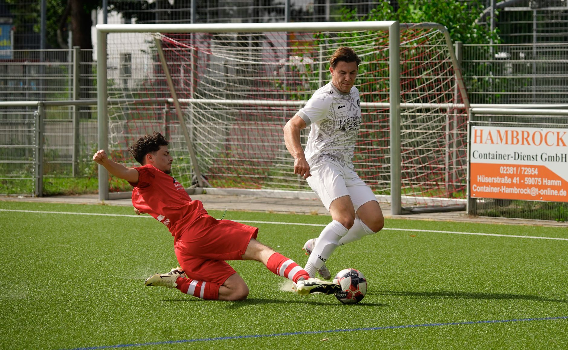 two football players vying for possession of the ball