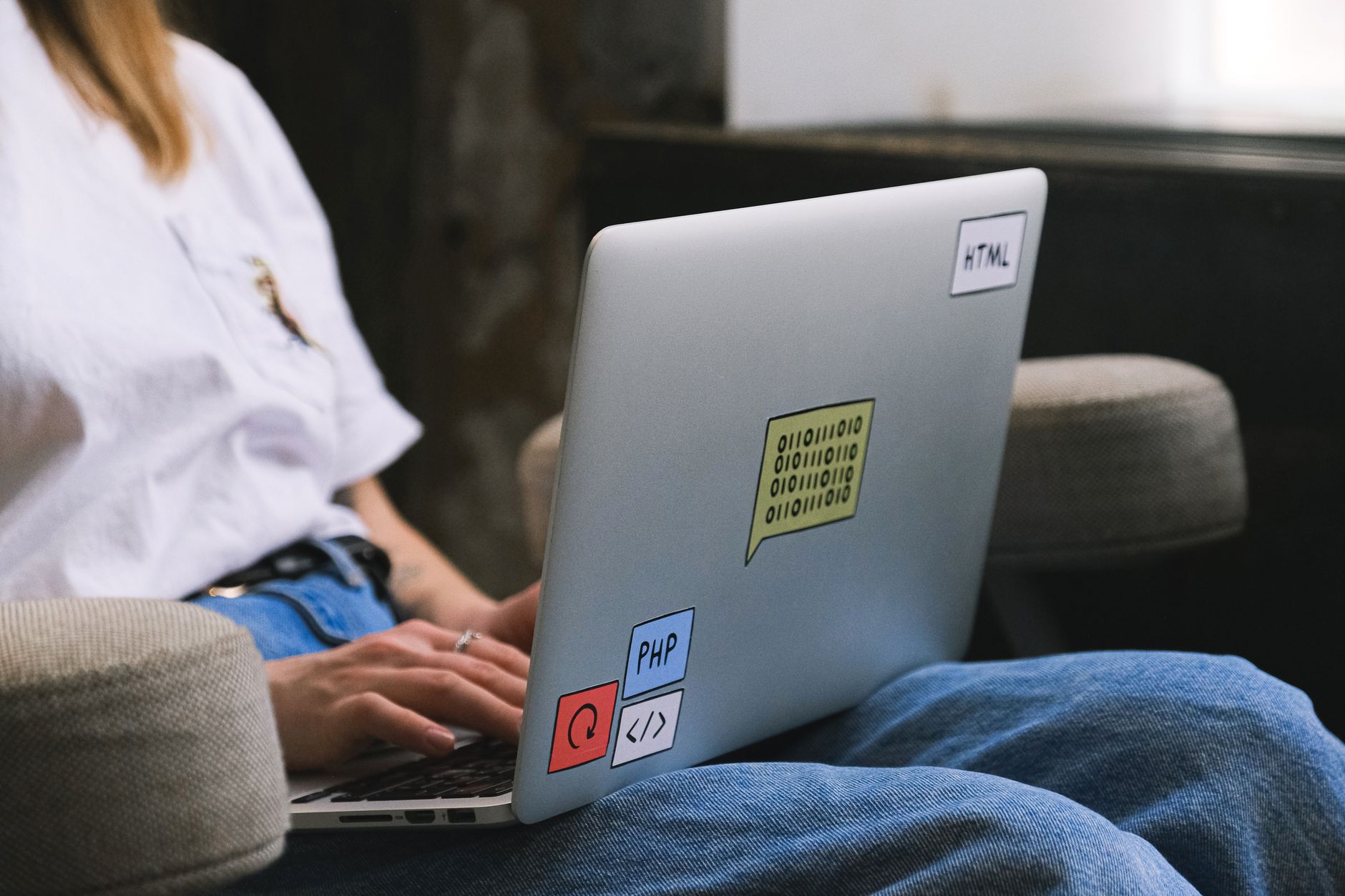 child coding on laptop with colorful blocks