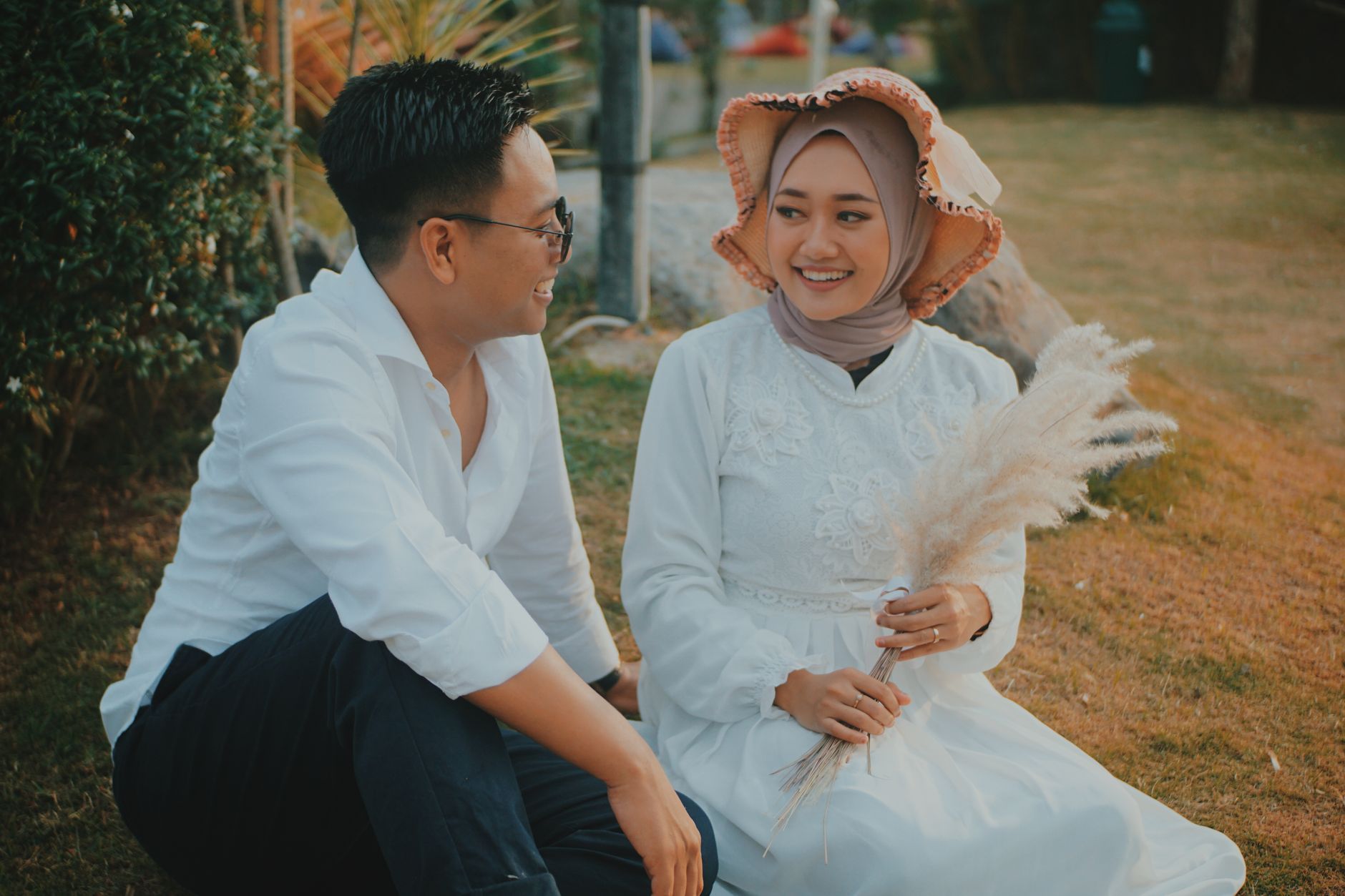 young couple walking in park holding hands