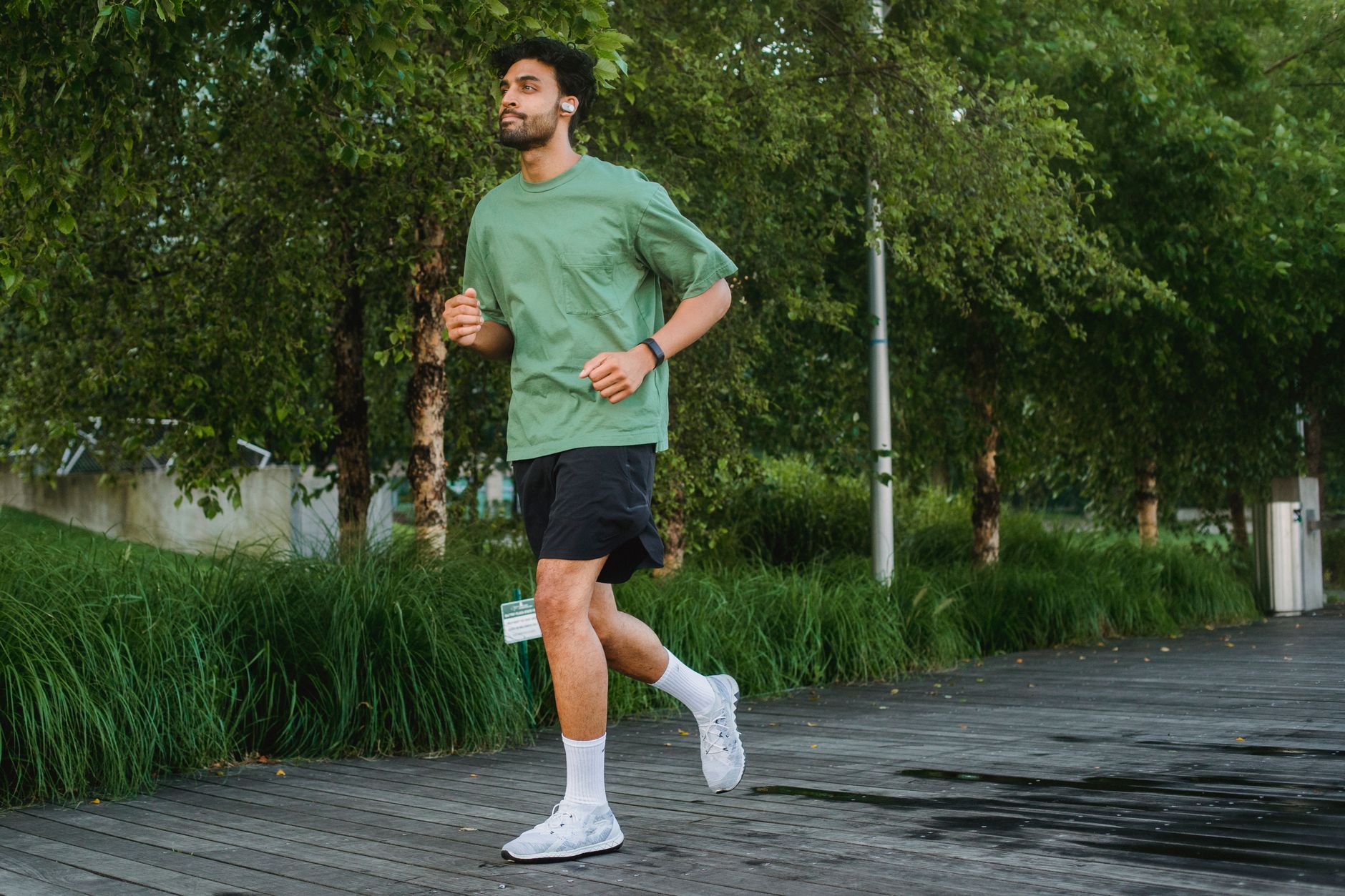 person jogging with smartphone arm band in park