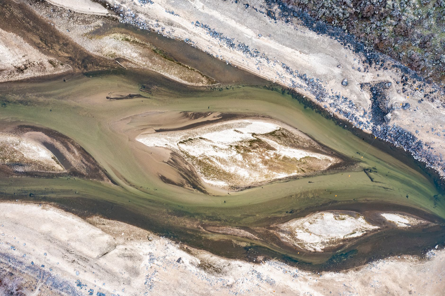 dry riverbed cracked earth aerial view