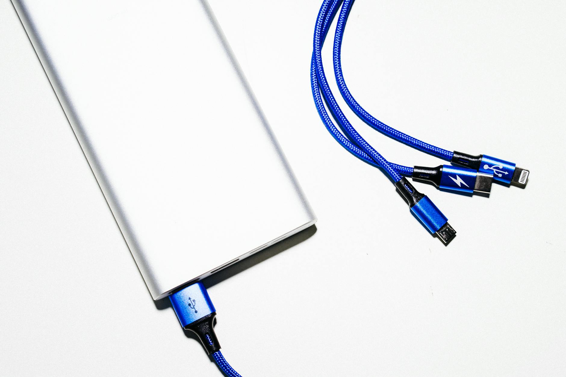 hand plugging USB-C cable into smartphone charging port
