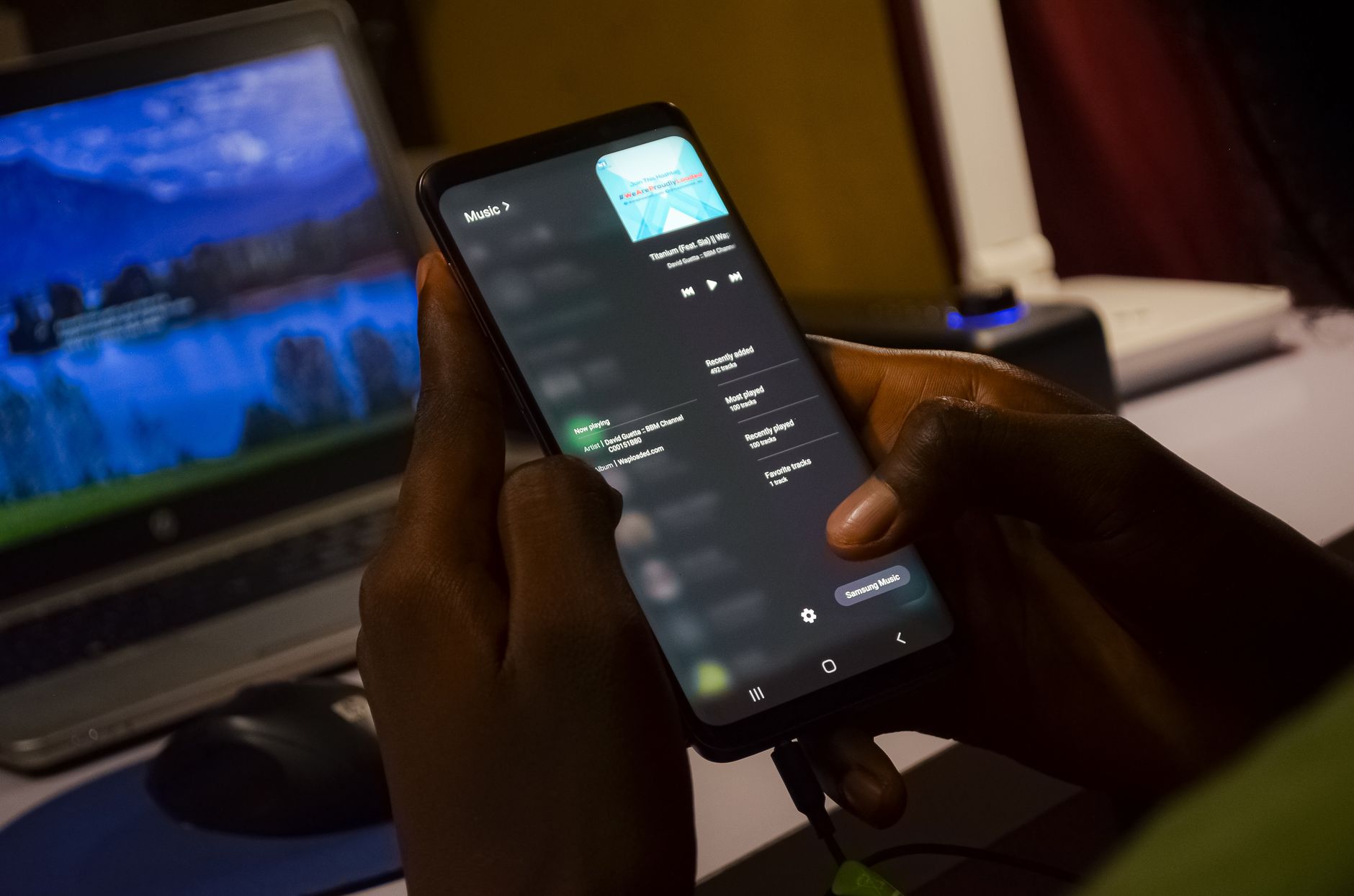 hand holding android phone with bright screen charging
