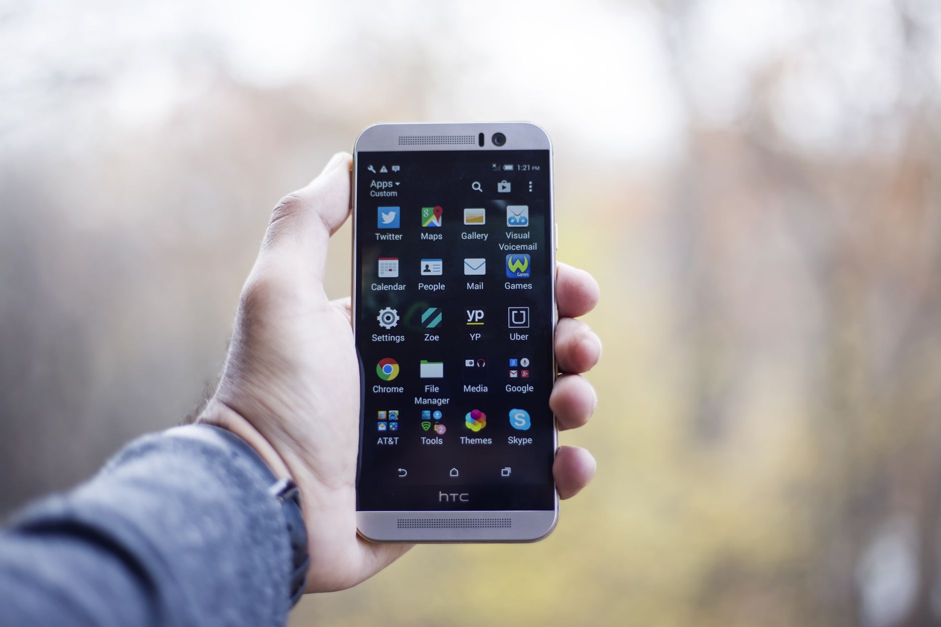hand holding android phone with bright screen outdoor