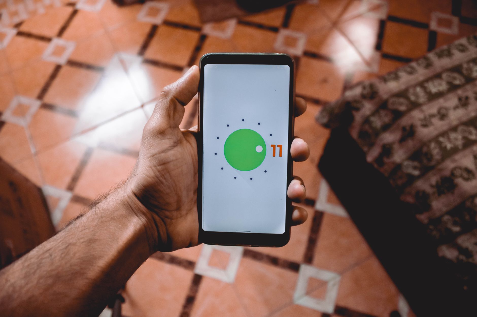 hand holding android phone with bright screen charging