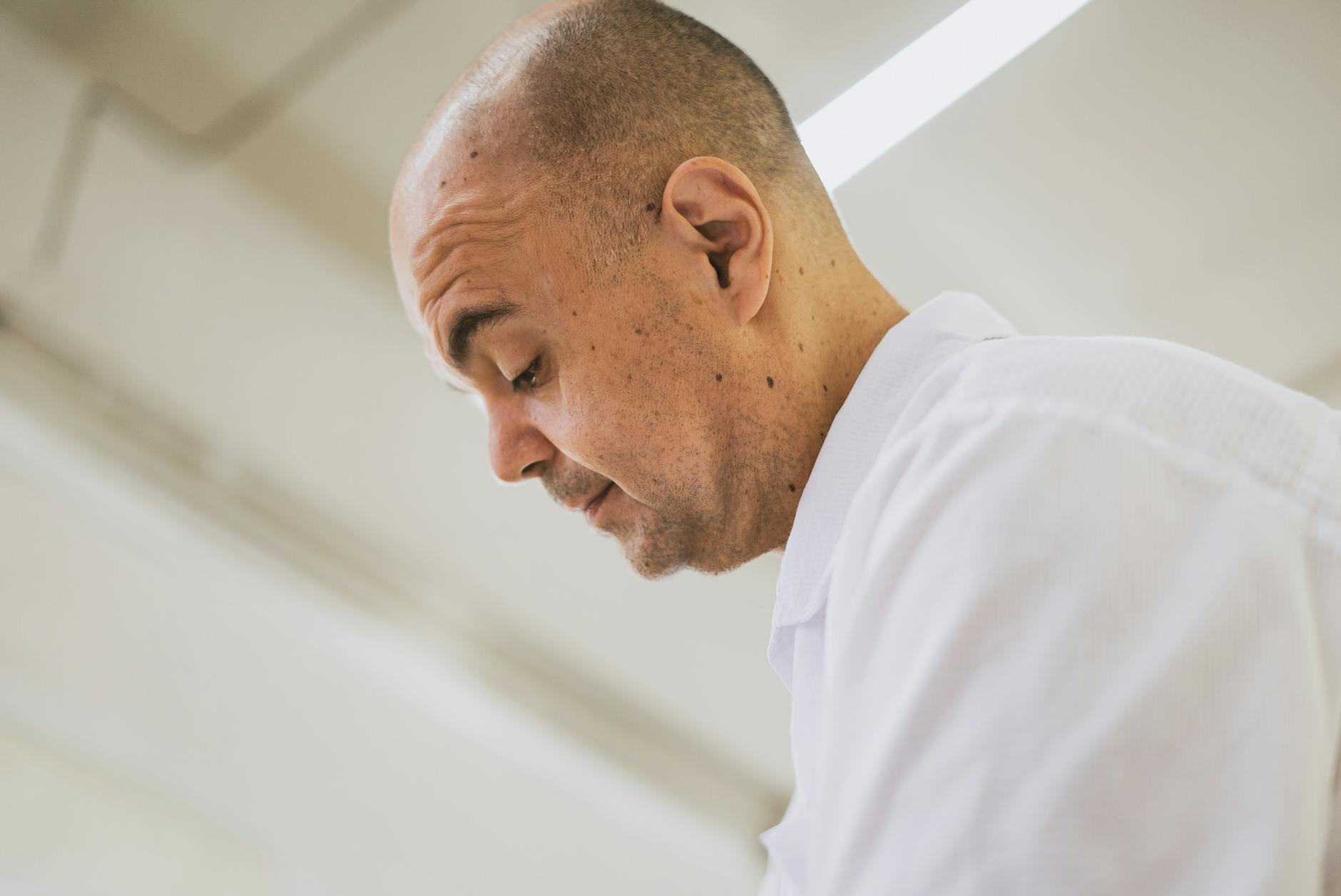 engineer examining silicon wafer in clean room