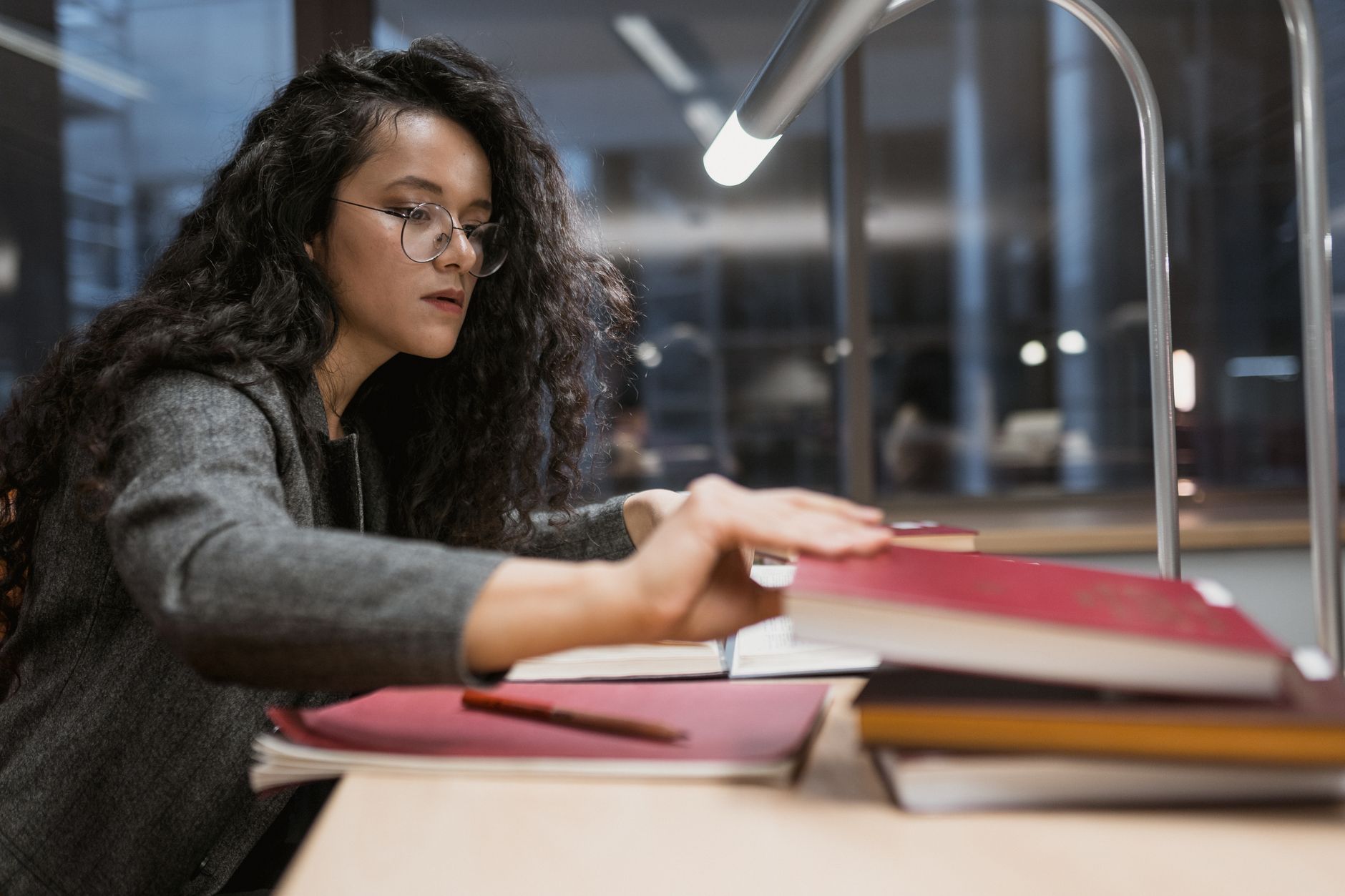 student studying at university library desk
