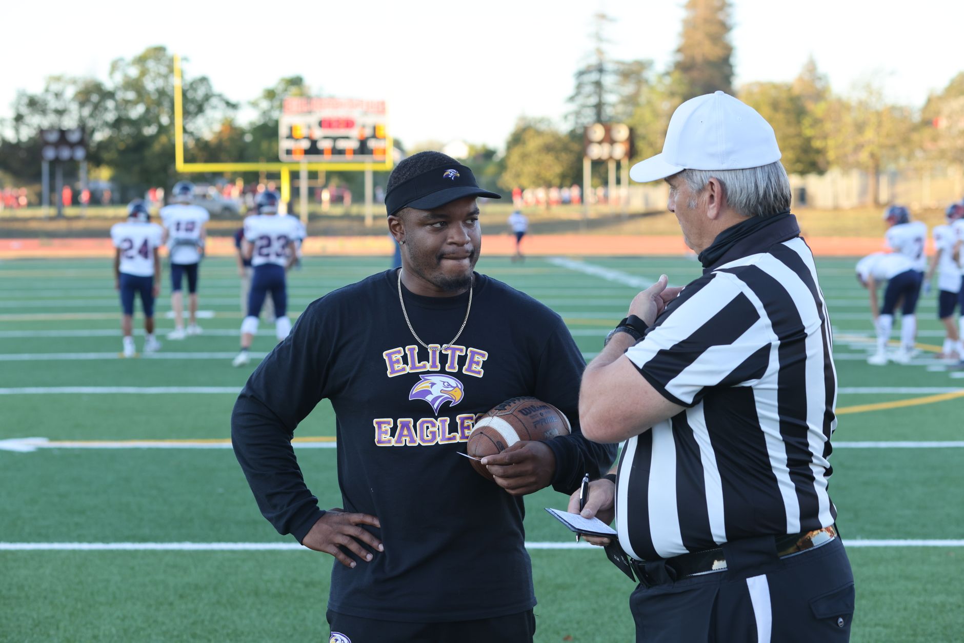 football coach giving instructions on sidelines