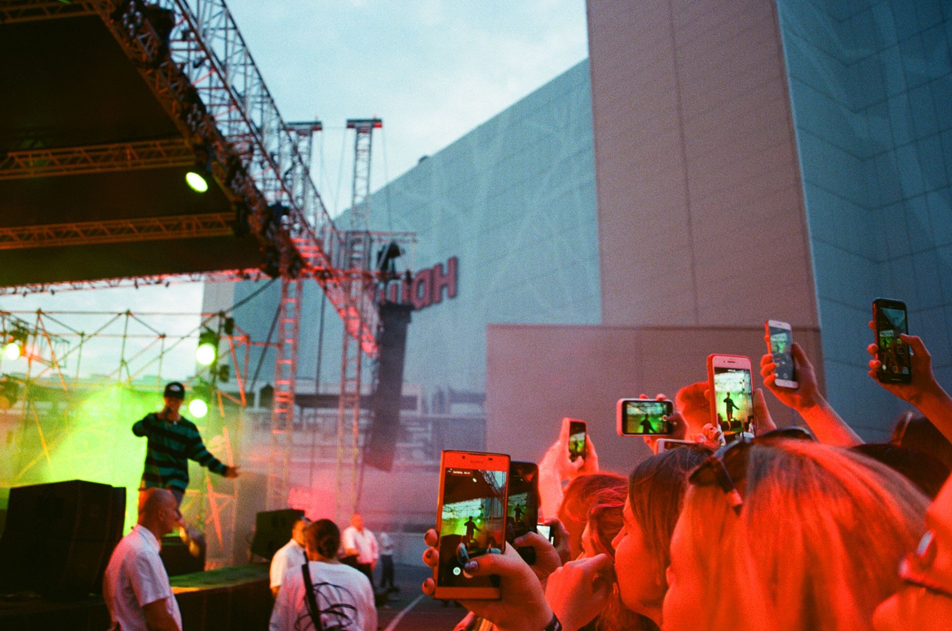 rapper performing on stage stadium bright lights